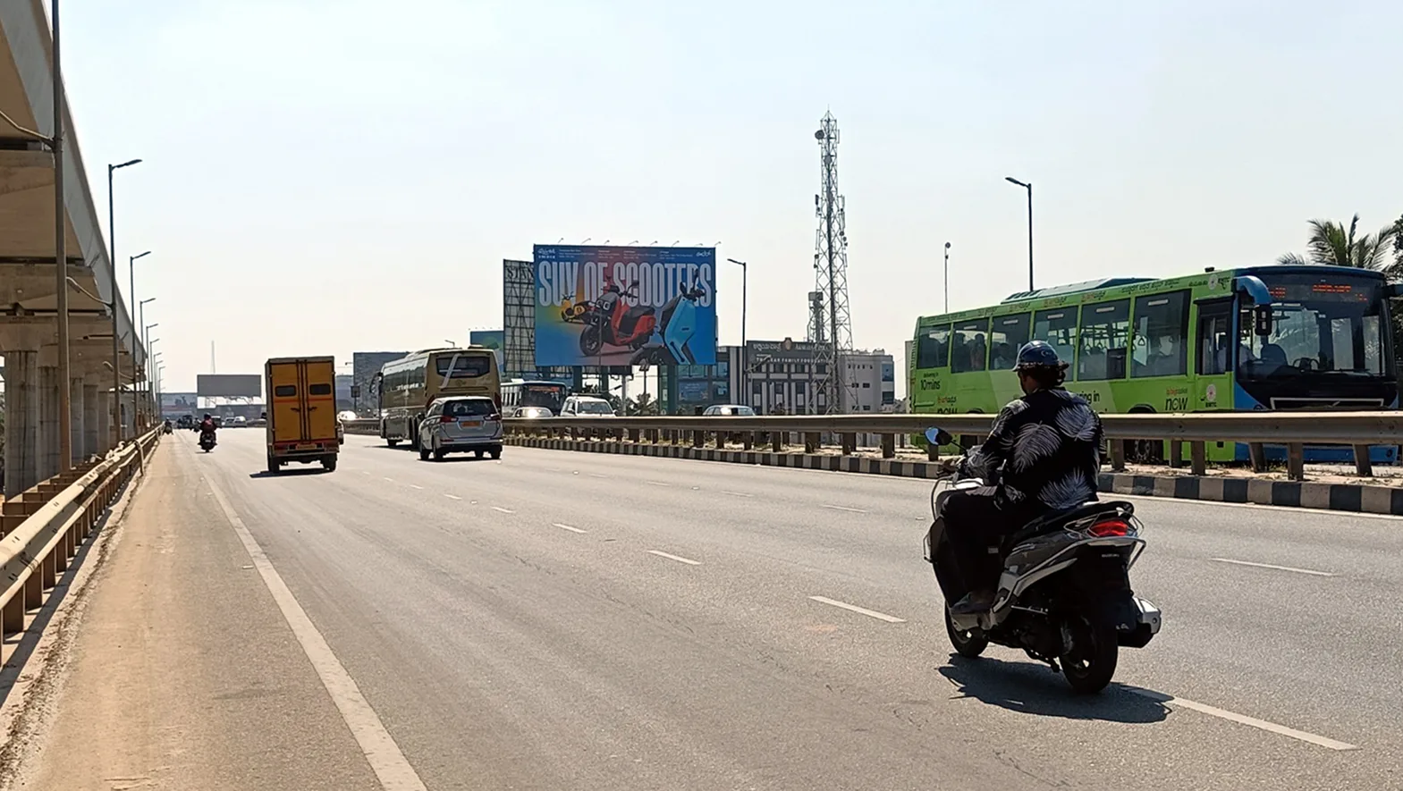 A roadside billboard in traffic